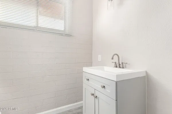 a bathroom with a sink a toilet and a window