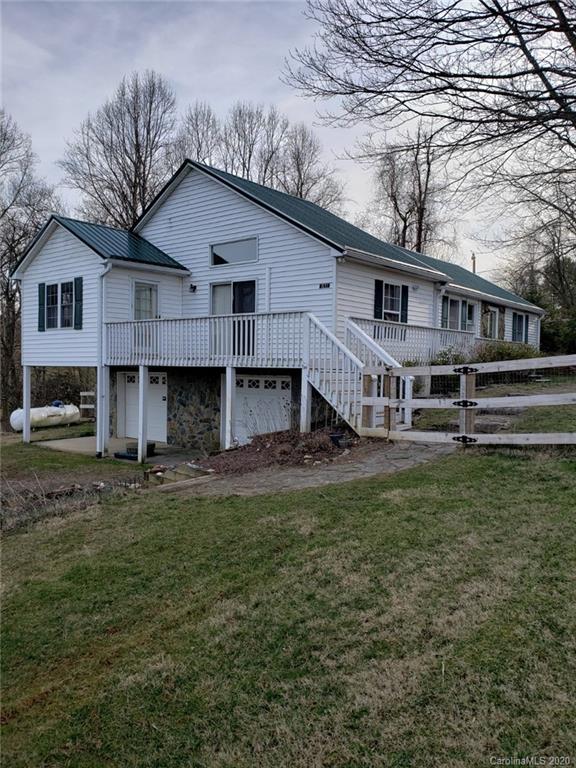 831 Dale Road Spruce Pine, NC 28777 - Photo 1 of 21 a view of a house with a big yard plants and large trees