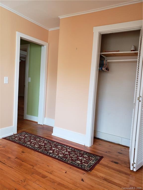 831 Dale Road Spruce Pine, NC 28777 - Photo 11 of 21 a view of a room with wooden floor and a carpet