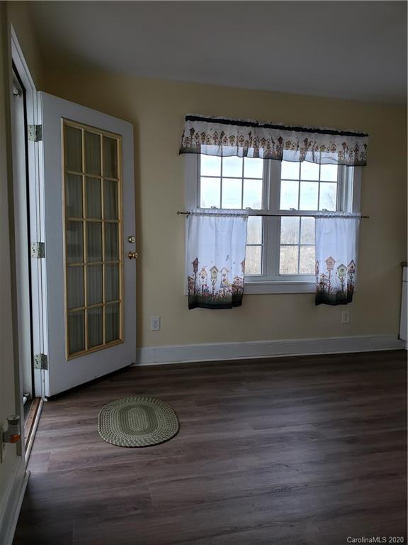 831 Dale Road Spruce Pine, NC 28777 - Photo 3 of 21 a view of wooden floor and windows in a room