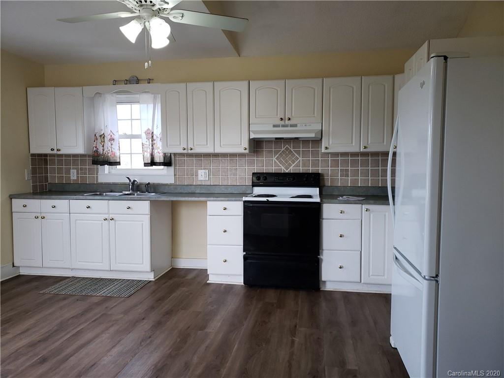 831 Dale Road Spruce Pine, NC 28777 - Photo 5 of 21 a kitchen with granite countertop a sink cabinets and stainless steel appliances