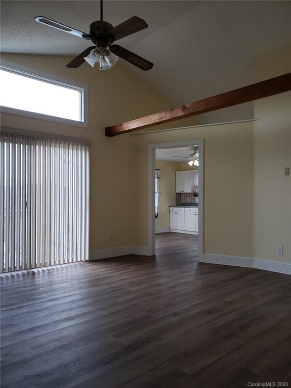 831 Dale Road Spruce Pine, NC 28777 - Photo 7 of 21 a view of an empty room with wooden floor and a window