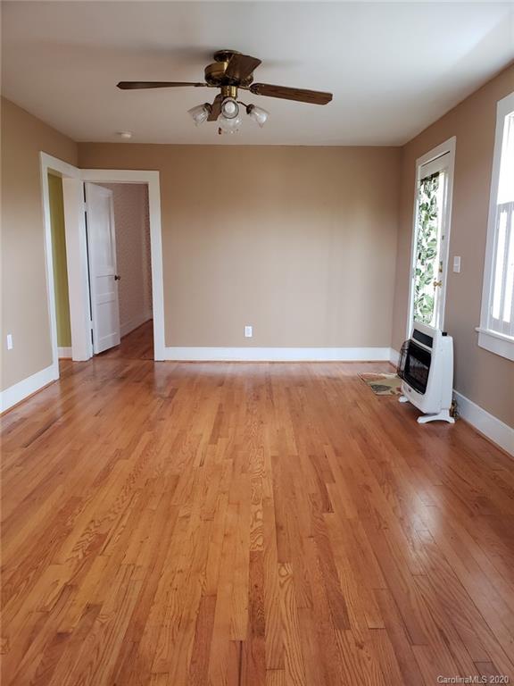 831 Dale Road Spruce Pine, NC 28777 - Photo 8 of 21 a view of an empty room with window and wooden floor