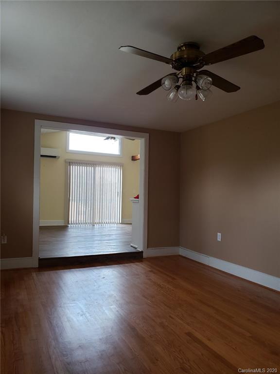 831 Dale Road Spruce Pine, NC 28777 - Photo 9 of 21 an empty room with wooden floor and windows