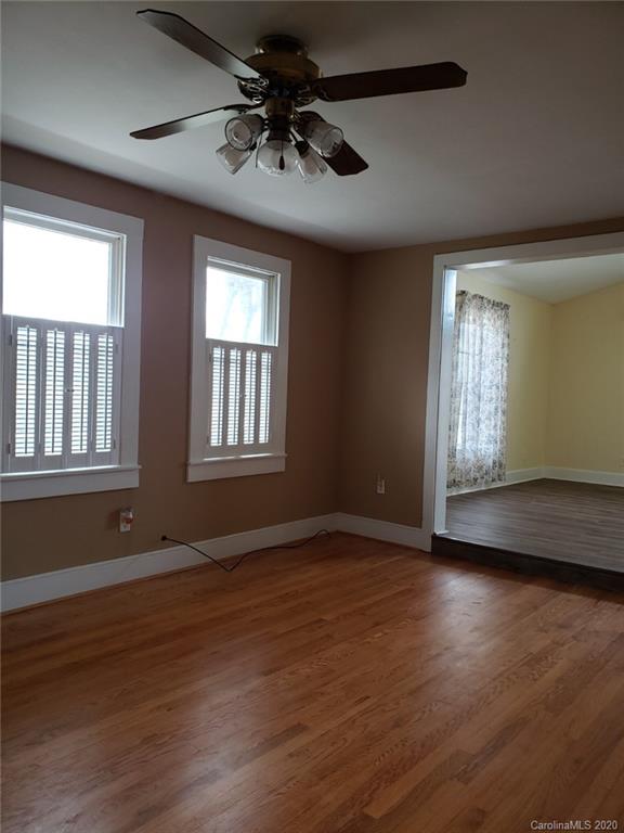 831 Dale Road Spruce Pine, NC 28777 - Photo 10 of 21 a view of an empty room with wooden floor and a window