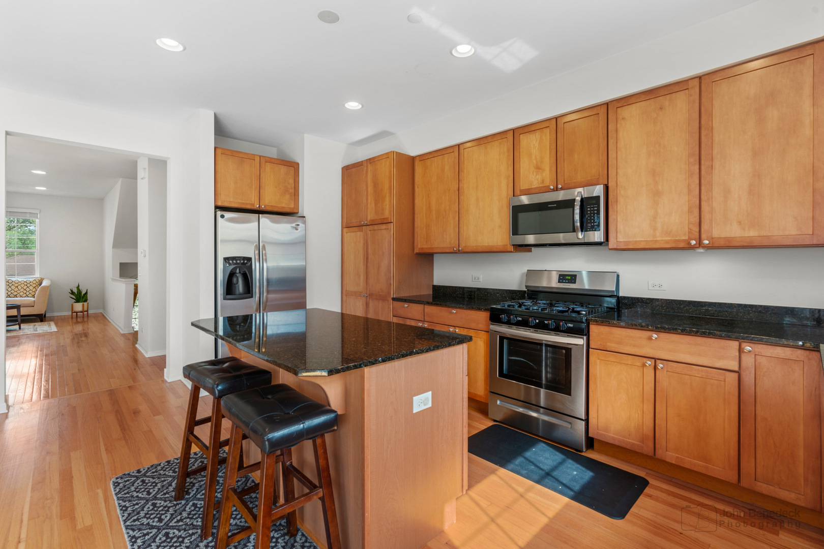 220 River Front Drive Mount Prospect, IL 60056 - Photo 12 of 33 a kitchen with stainless steel appliances granite countertop a stove a sink a microwave a refrigerator and cabinets