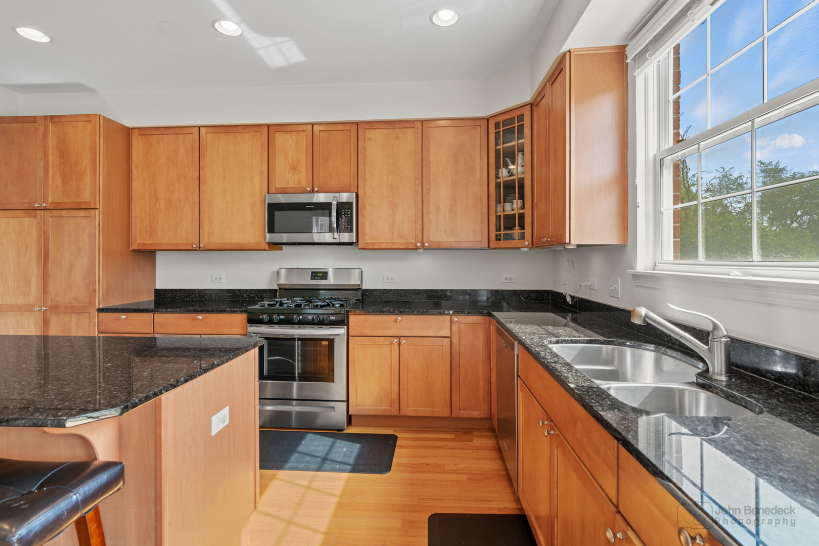 220 River Front Drive Mount Prospect, IL 60056 - Photo 14 of 33 a kitchen with stainless steel appliances granite countertop a stove a sink and a microwave