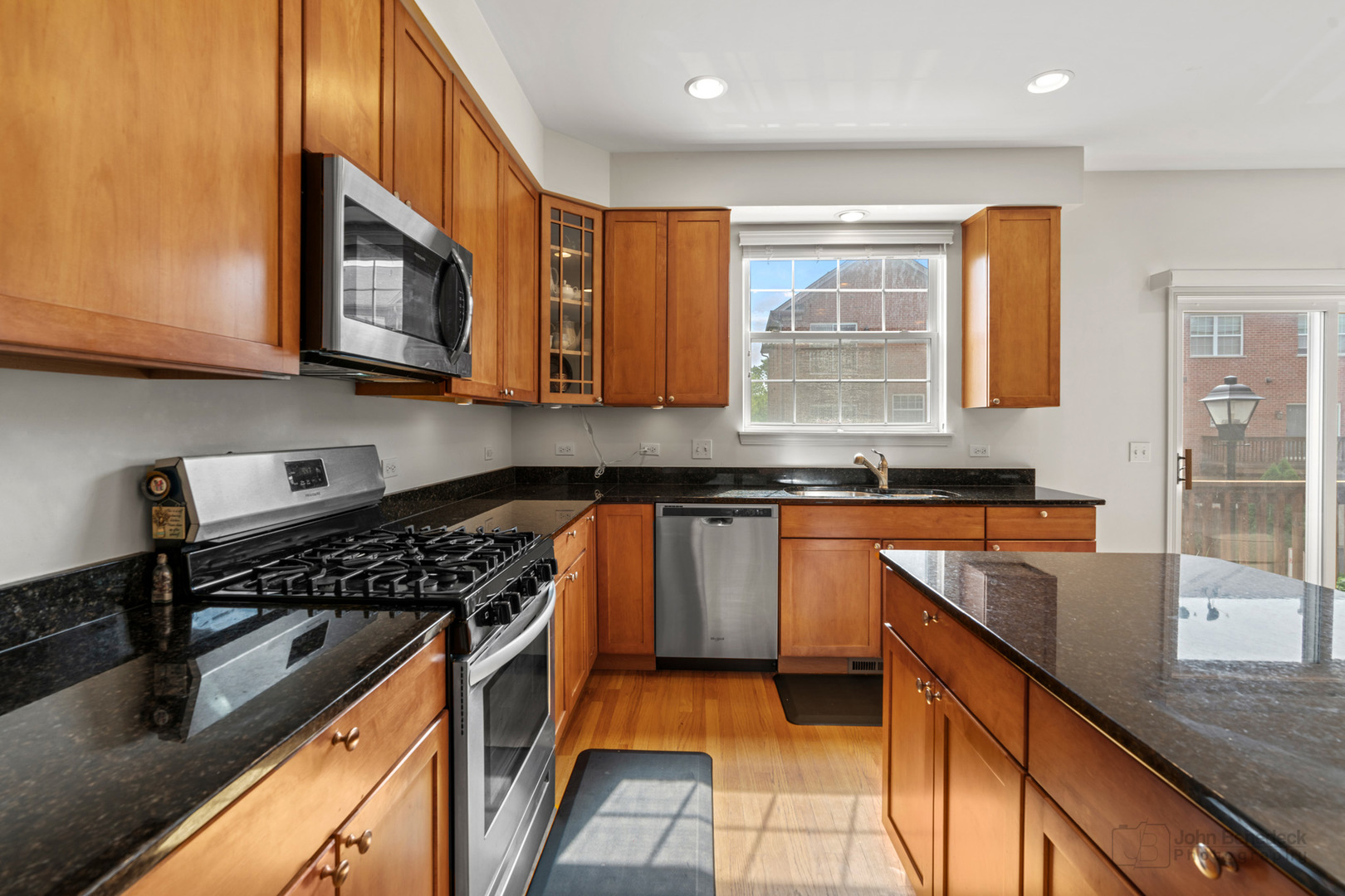 220 River Front Drive Mount Prospect, IL 60056 - Photo 16 of 33 a kitchen with stainless steel appliances granite countertop a stove a sink and a microwave