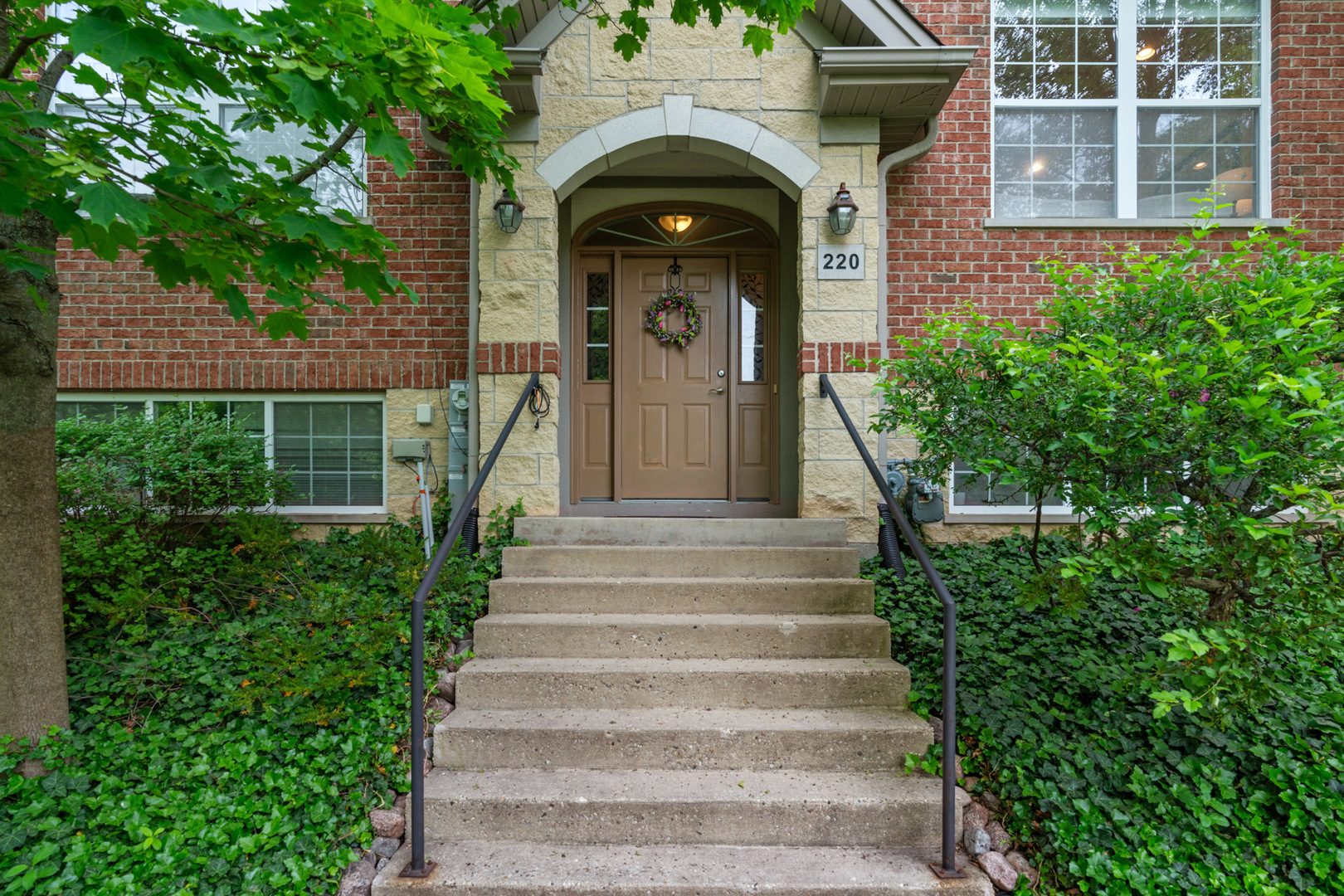 220 River Front Drive Mount Prospect, IL 60056 - Photo 2 of 33 a view of a house with large windows and a small yard