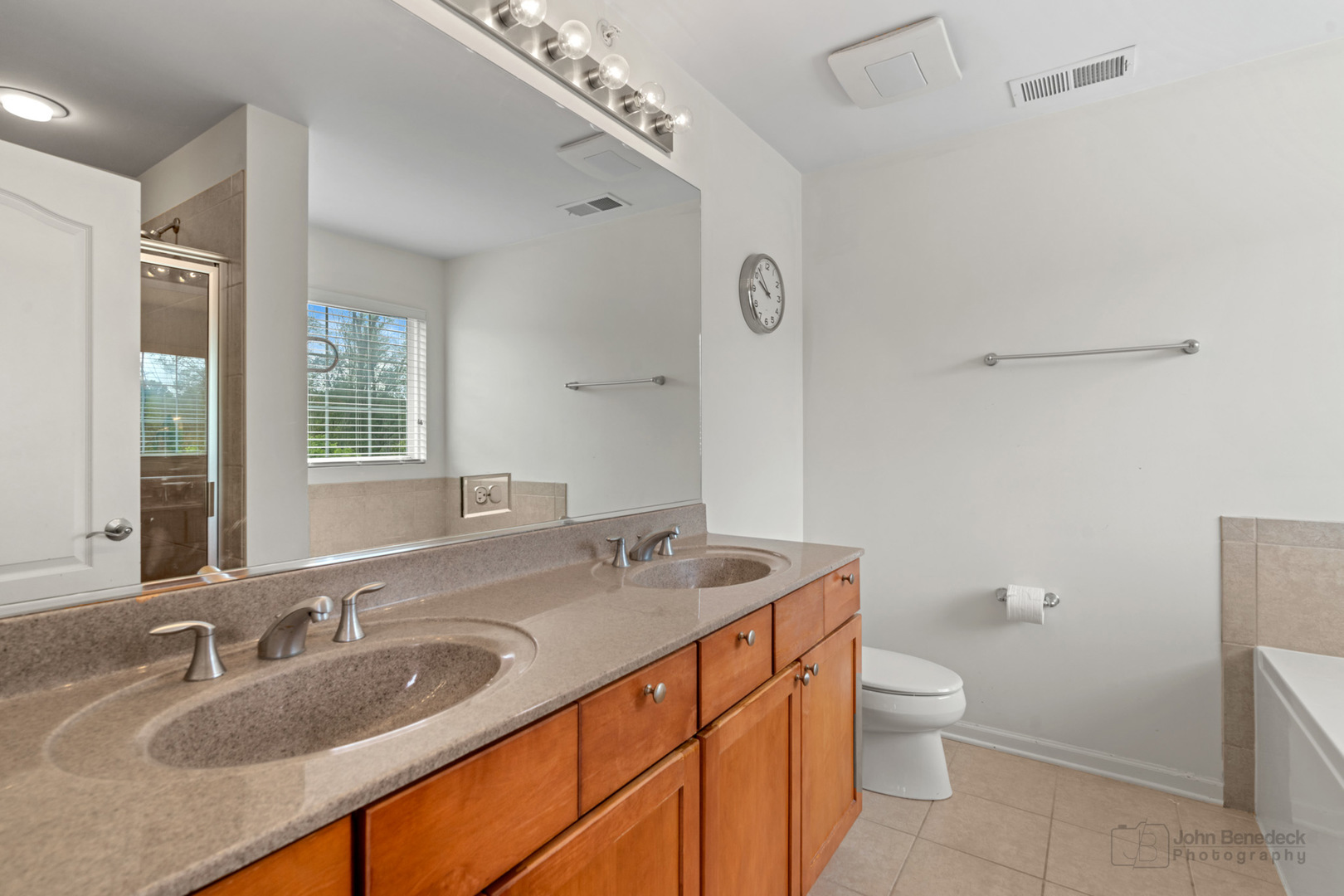 220 River Front Drive Mount Prospect, IL 60056 - Photo 21 of 33 a bathroom with a granite countertop sink a large mirror a toilet and a shower
