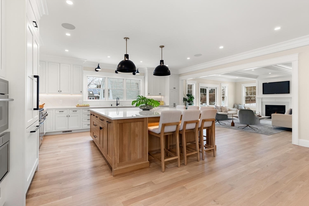 2 Abby Road Winchester, MA 01890 - Photo 11 of 42 a kitchen with stainless steel appliances kitchen island granite countertop a sink and a refrigerator