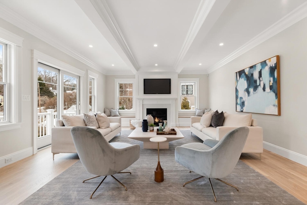 2 Abby Road Winchester, MA 01890 - Photo 17 of 42 a living room with furniture a fireplace and a flat screen tv