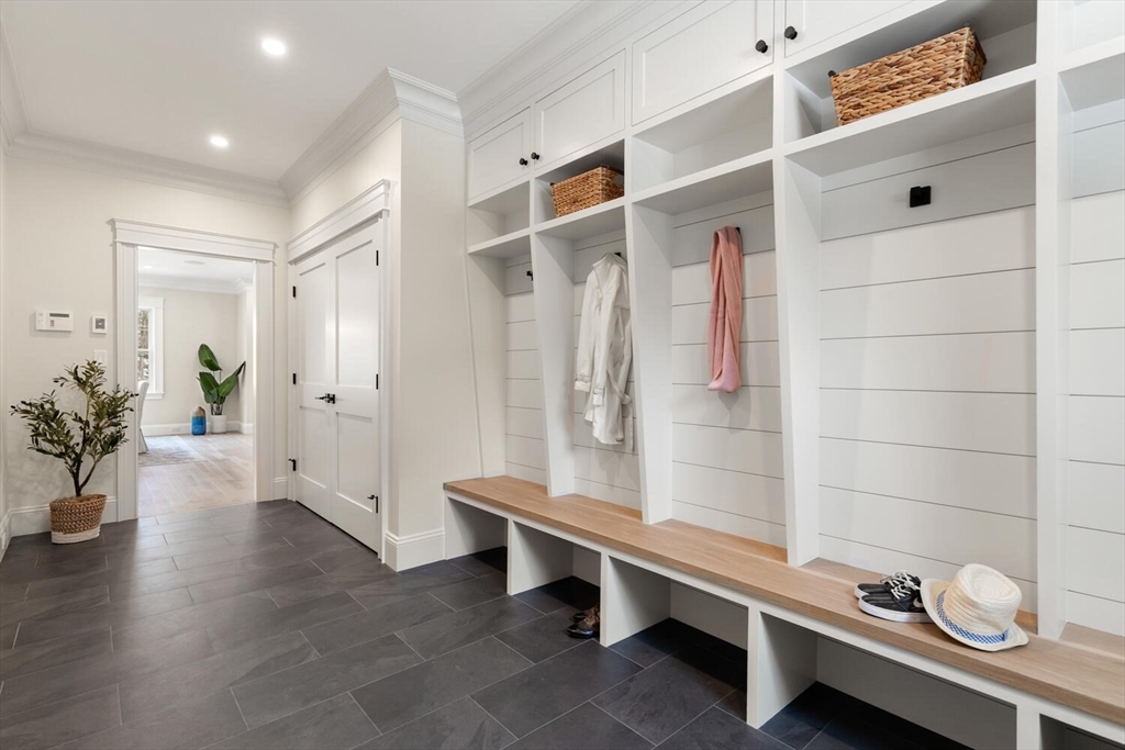 2 Abby Road Winchester, MA 01890 - Photo 19 of 42 a hallway with a wooden floor and a potted plant