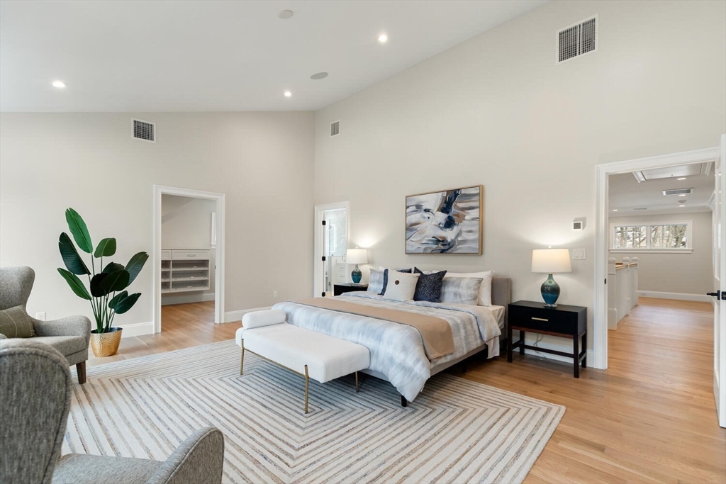 2 Abby Road Winchester, MA 01890 - Photo 23 of 42 a bedroom with a bed a couch and potted plant with wooden floor