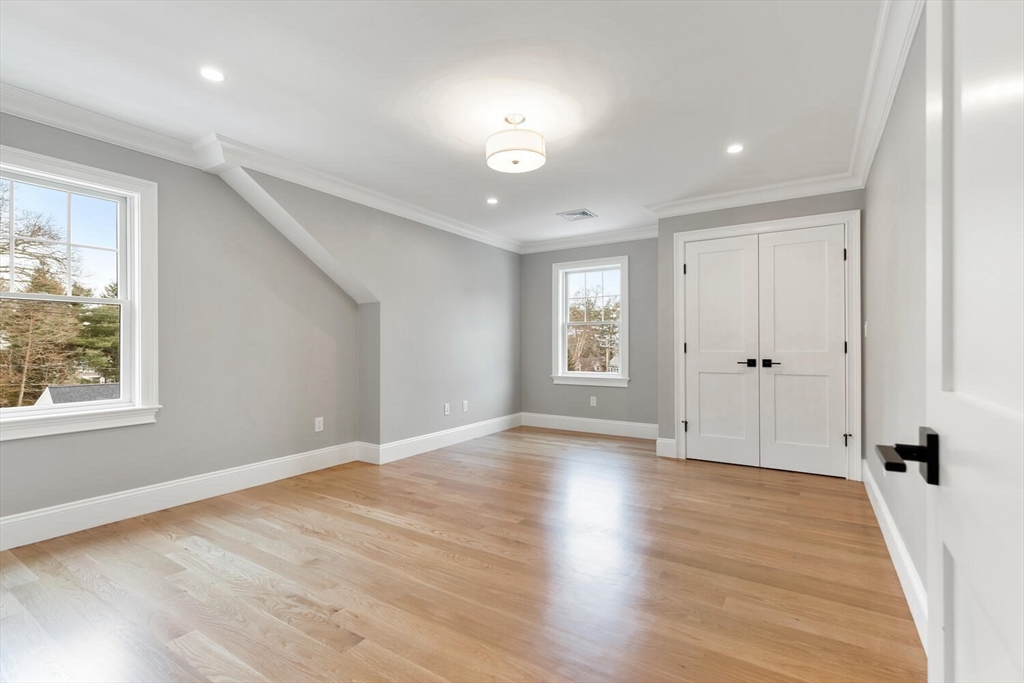 2 Abby Road Winchester, MA 01890 - Photo 26 of 42 an empty room with wooden floor and windows