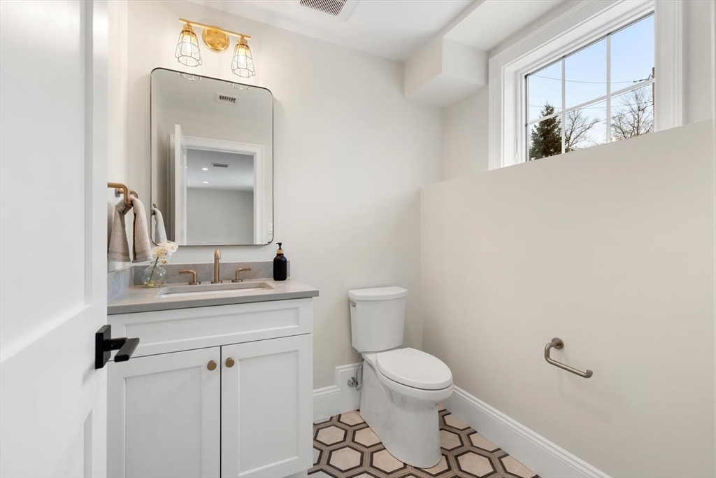 2 Abby Road Winchester, MA 01890 - Photo 33 of 42 a bathroom with a toilet a sink and mirror