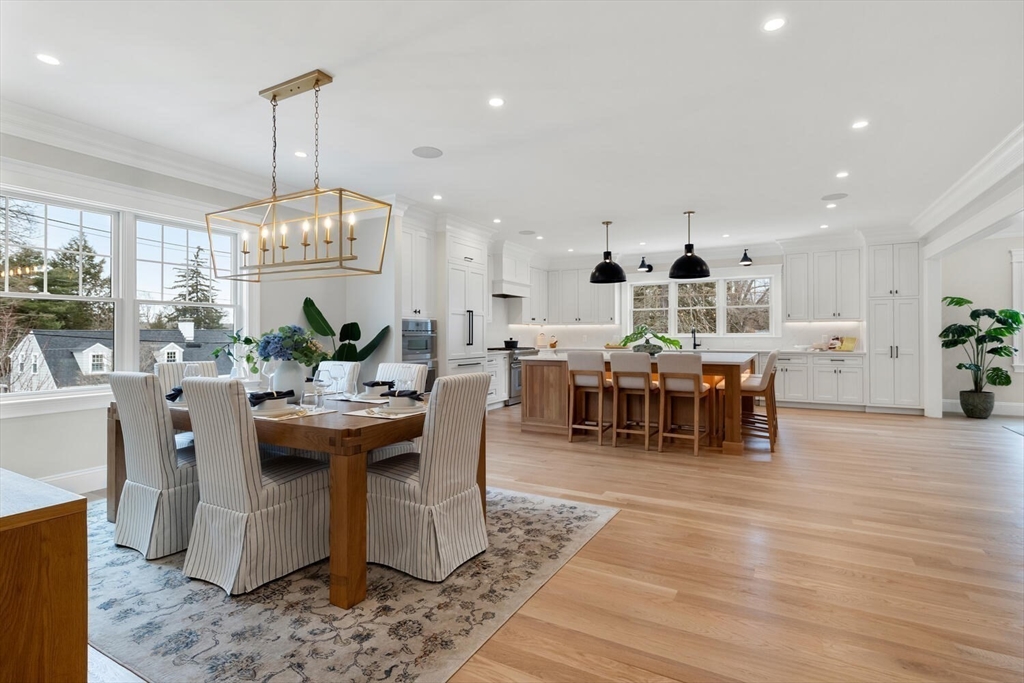 2 Abby Road Winchester, MA 01890 - Photo 10 of 42 a view of a dining room and livingroom with furniture wooden floor a chandelier