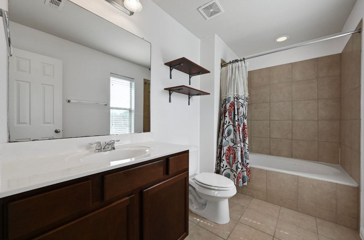 11248 Lost Maples Trail, Unit 11248 Austin, TX 78748 - Photo 18 of 22 a bathroom with a sink a toilet and shower