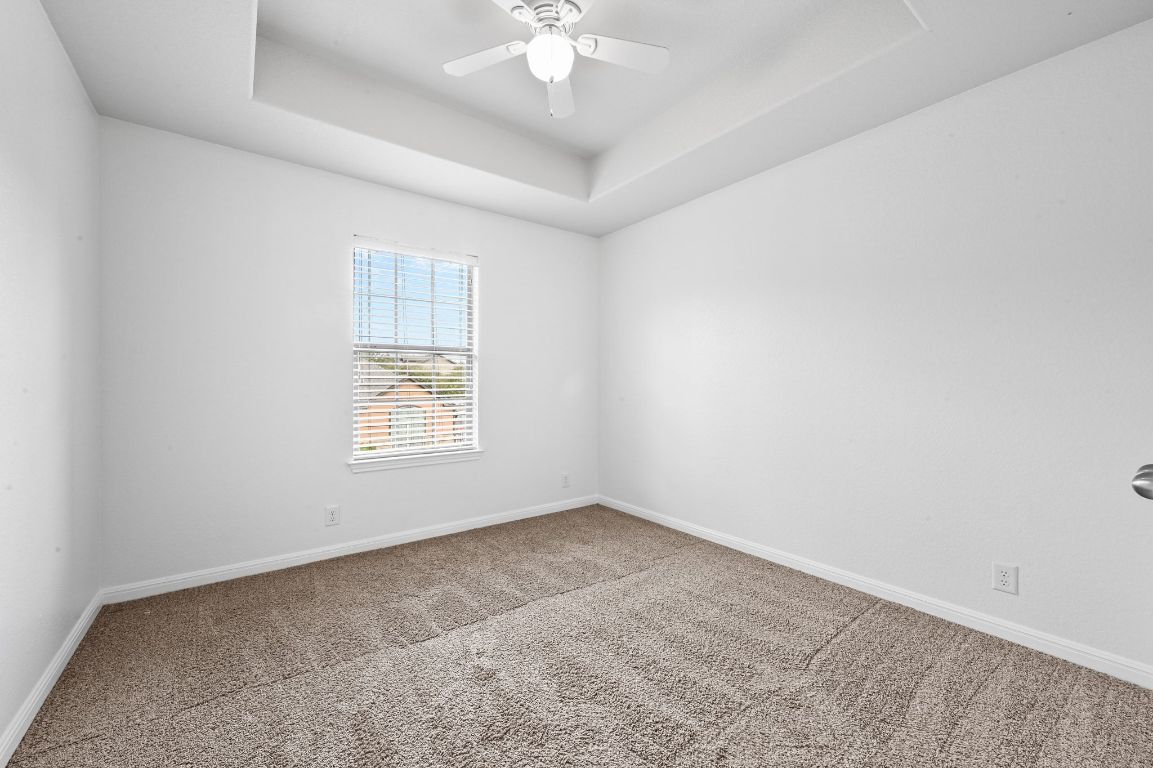 11248 Lost Maples Trail, Unit 11248 Austin, TX 78748 - Photo 19 of 22 an empty room with a window and a ceiling fan