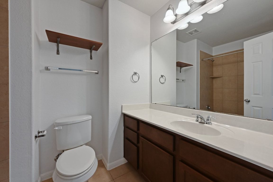 11248 Lost Maples Trail, Unit 11248 Austin, TX 78748 - Photo 20 of 22 a bathroom with a toilet a sink and mirror