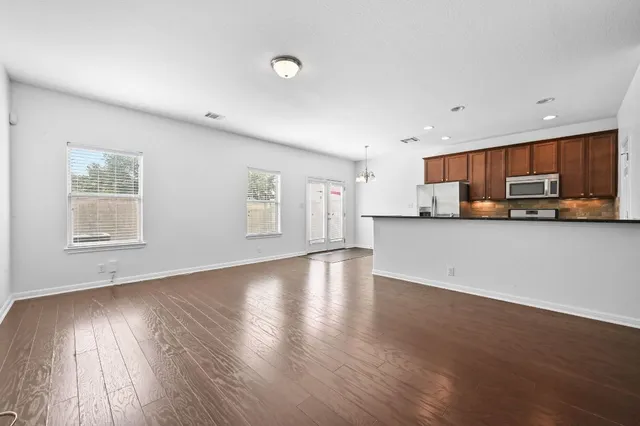 a view of a kitchen with a sink cabinets and wooden floor