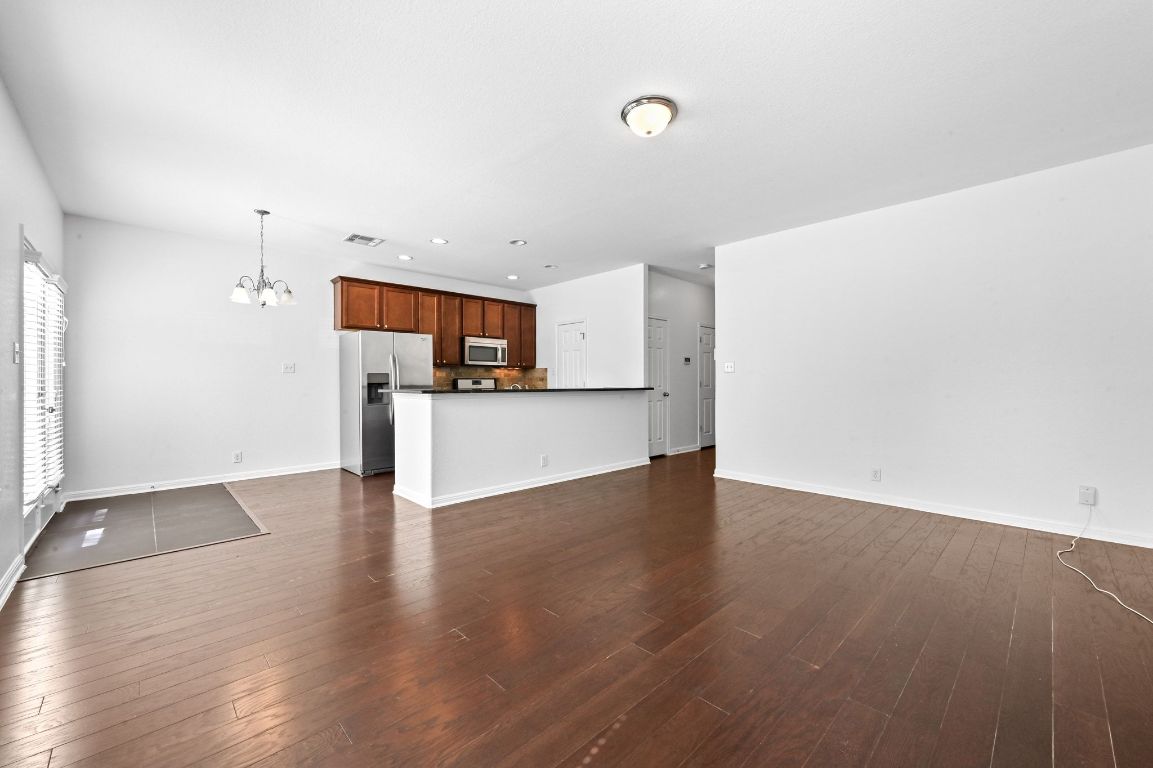 11248 Lost Maples Trail, Unit 11248 Austin, TX 78748 - Photo 7 of 22 a view of a kitchen with a sink and a microwave