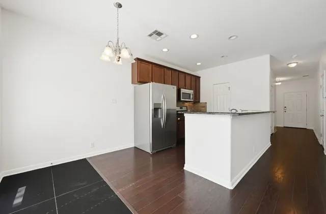 a view of a kitchen with wooden floor