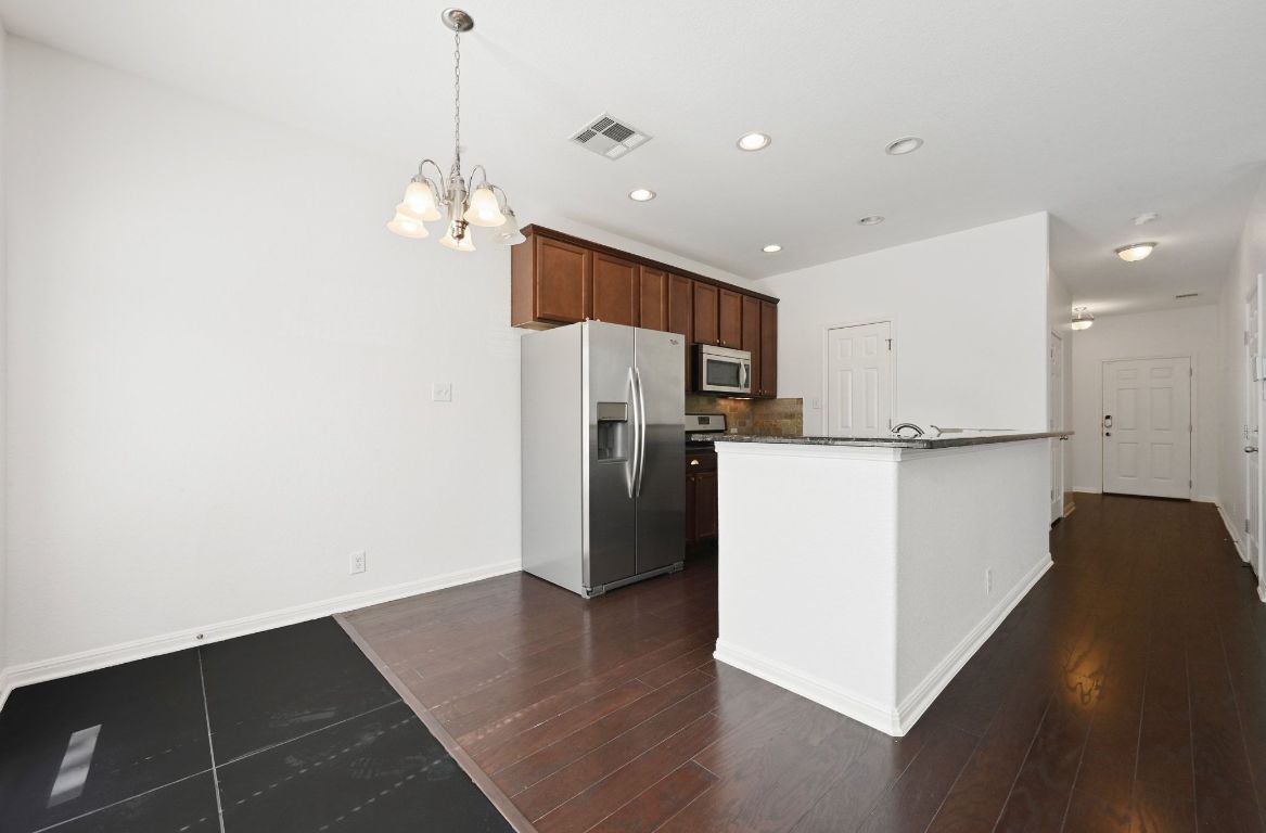11248 Lost Maples Trail, Unit 11248 Austin, TX 78748 - Photo 8 of 22 a view of a kitchen with wooden floor