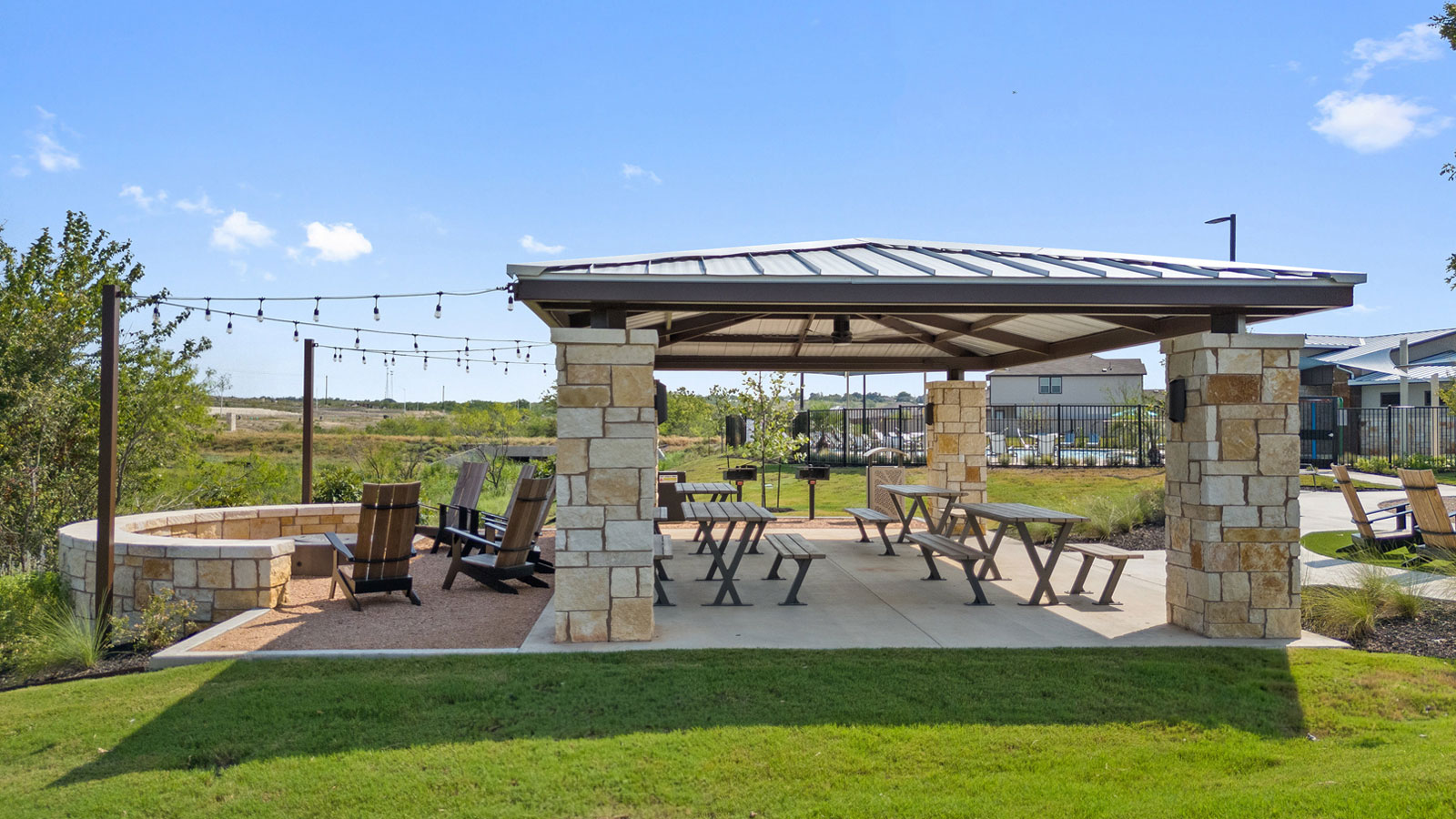 236 Gilmer Lane Buda, TX 78610 - Photo 27 of 30 a view of a patio with table and chairs under an umbrella with a big yard