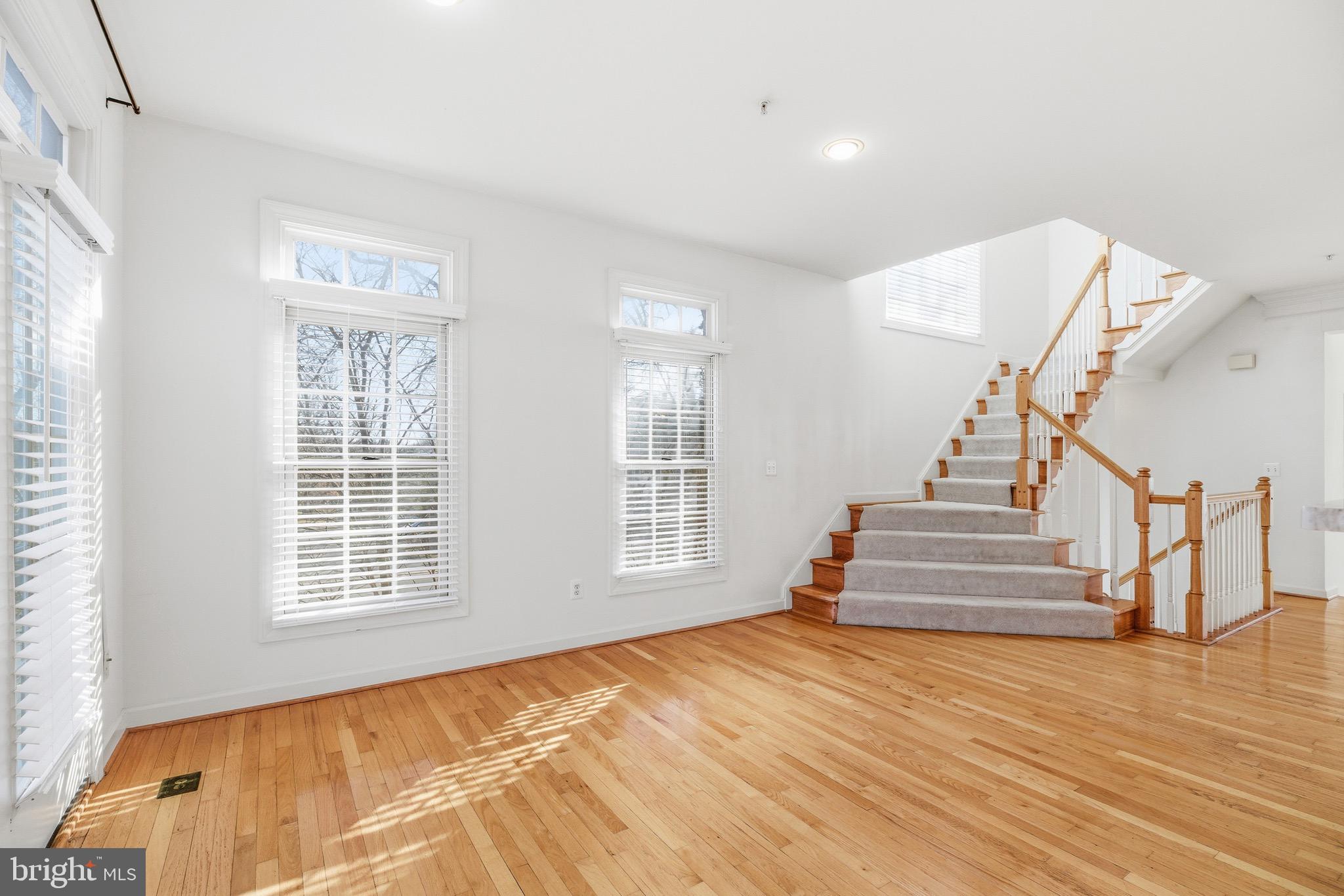 1817 Fallbrook Lane Vienna, VA 22182 - Photo 12 of 50 a view of an empty room with wooden floor and a window