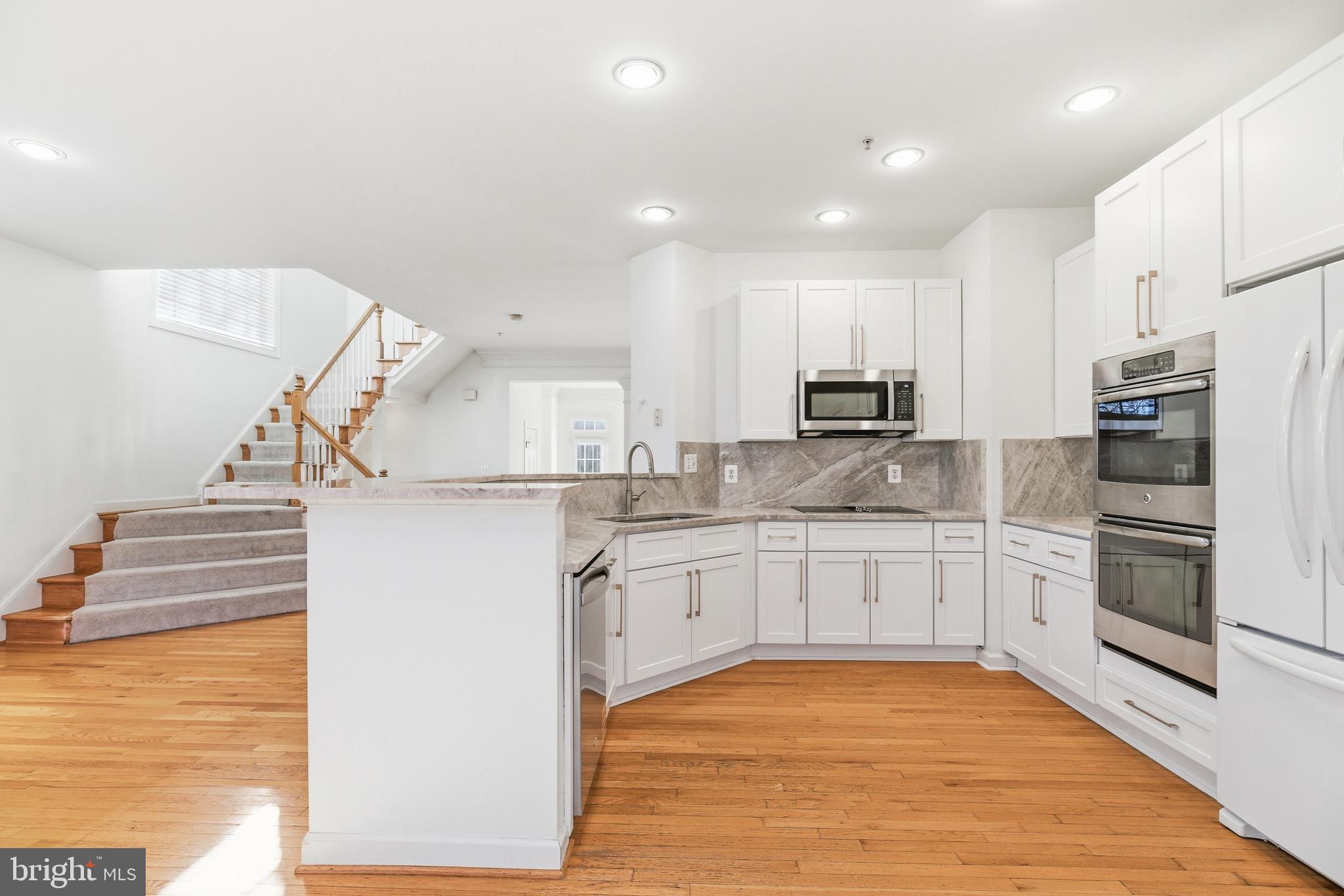 1817 Fallbrook Lane Vienna, VA 22182 - Photo 13 of 50 a kitchen with stainless steel appliances granite countertop a refrigerator and a stove top oven