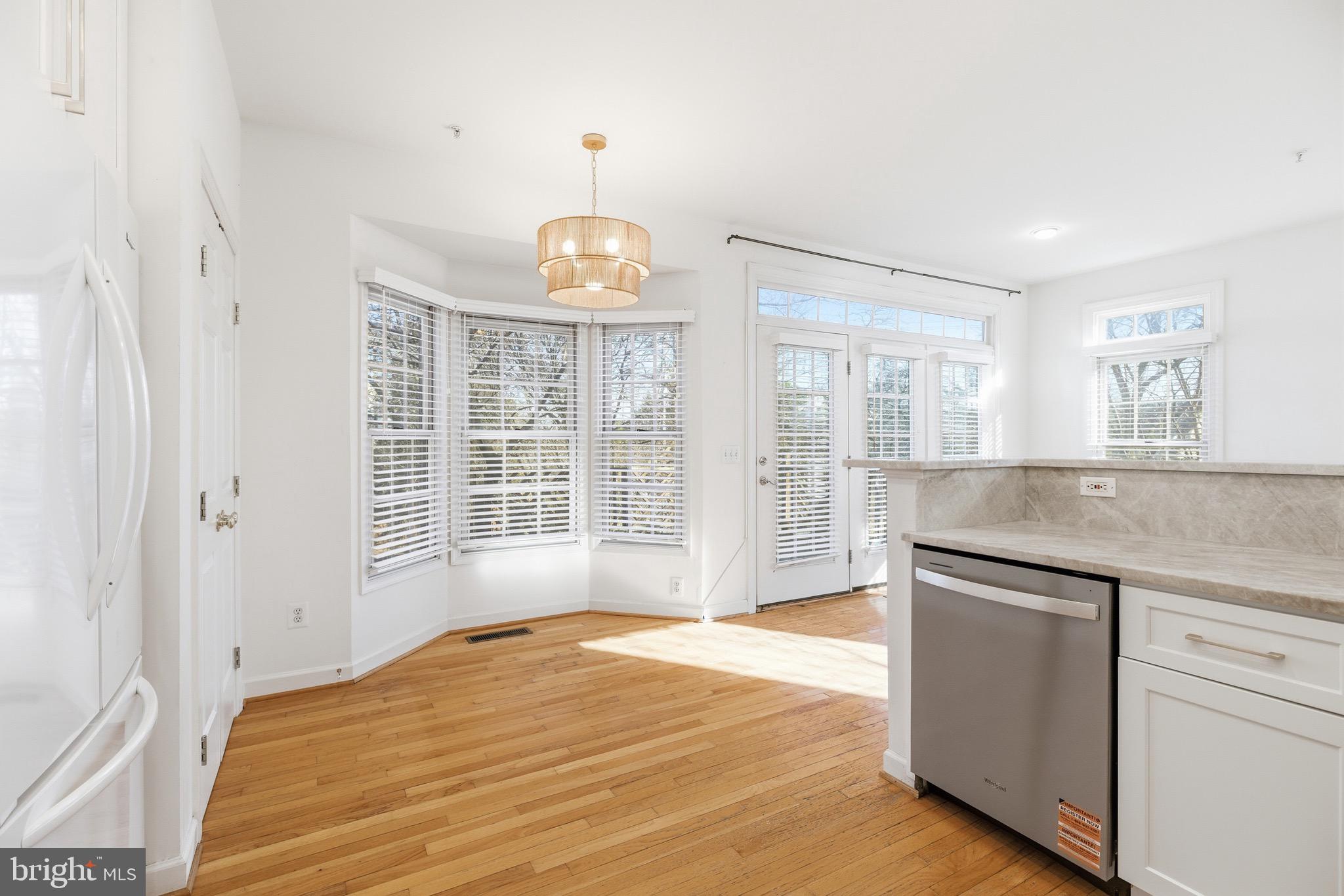 1817 Fallbrook Lane Vienna, VA 22182 - Photo 14 of 50 a view of an empty room with wooden floor and a window