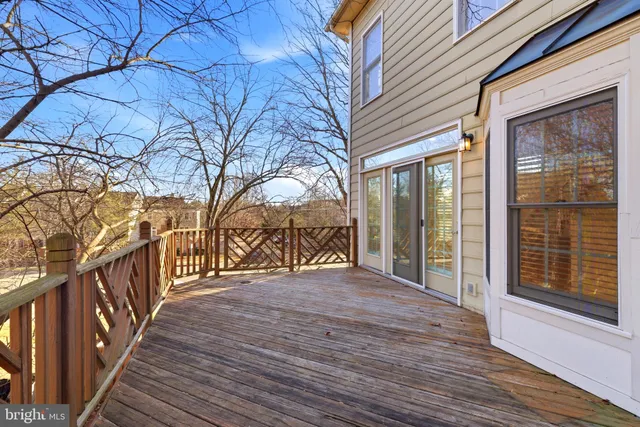 a view of a wooden deck besides a house