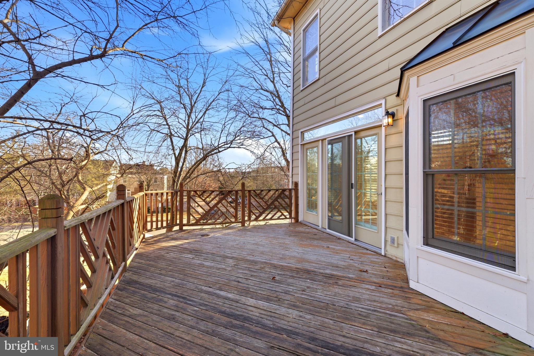 1817 Fallbrook Lane Vienna, VA 22182 - Photo 18 of 50 a view of a wooden deck besides a house