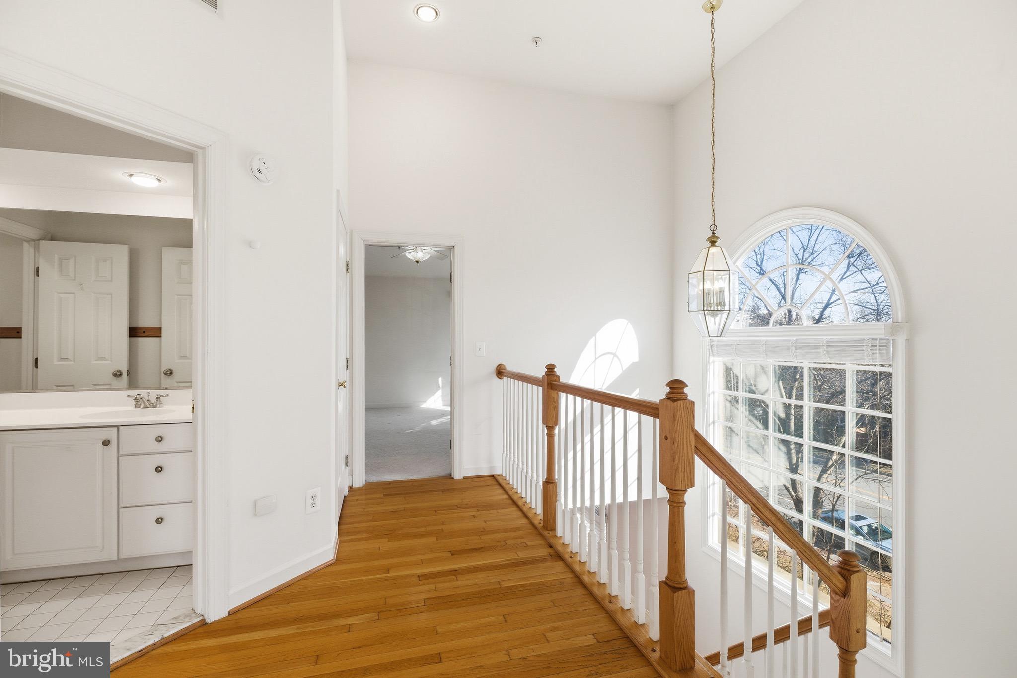 1817 Fallbrook Lane Vienna, VA 22182 - Photo 20 of 50 a view of a hallway with wooden floor and windows