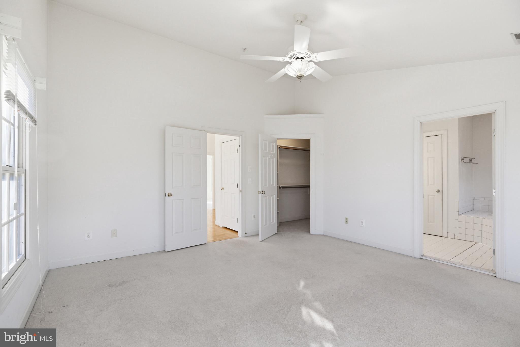 1817 Fallbrook Lane Vienna, VA 22182 - Photo 22 of 50 an empty room with chandelier fan and windows