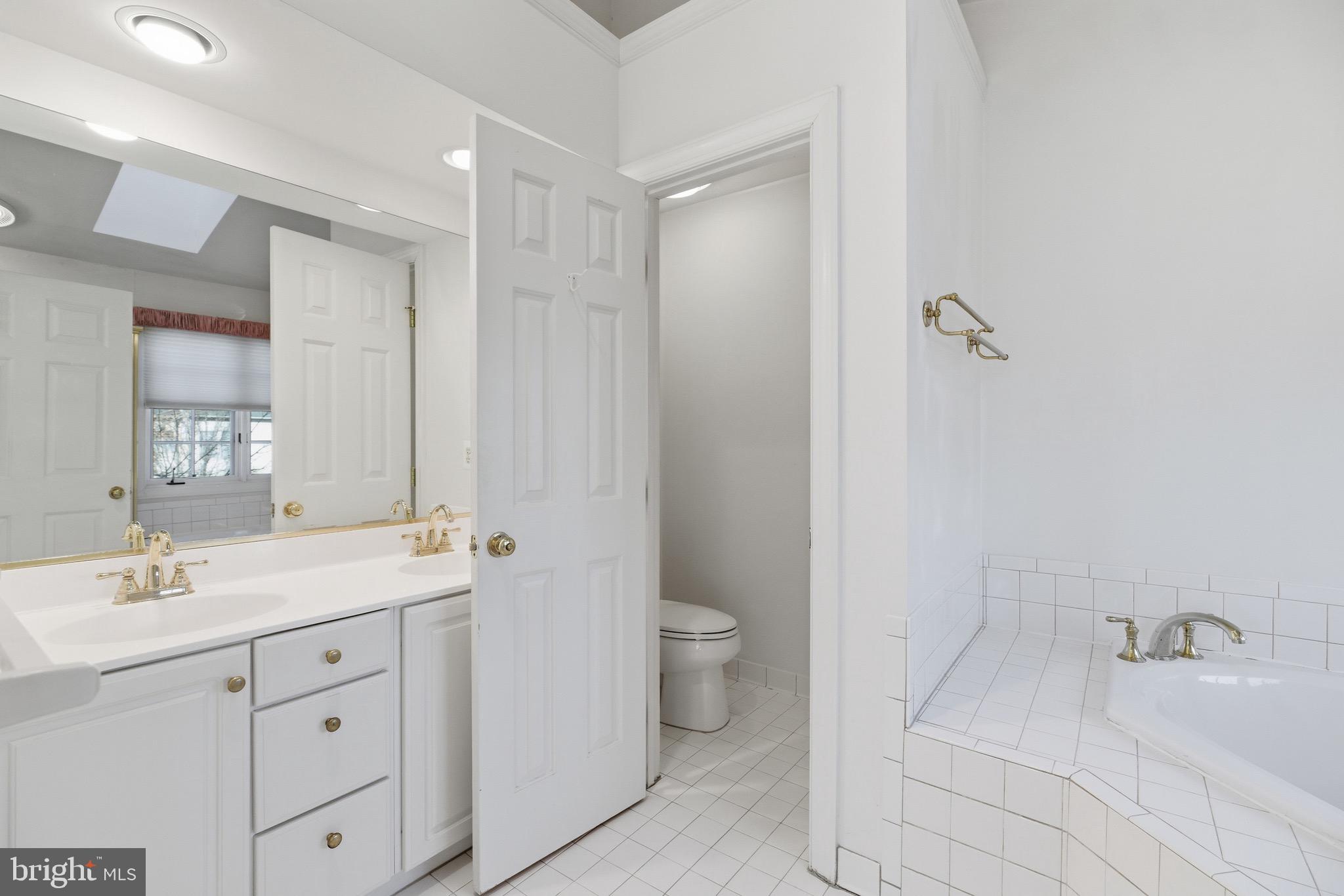 1817 Fallbrook Lane Vienna, VA 22182 - Photo 23 of 50 a bathroom with a sink a toilet and shower