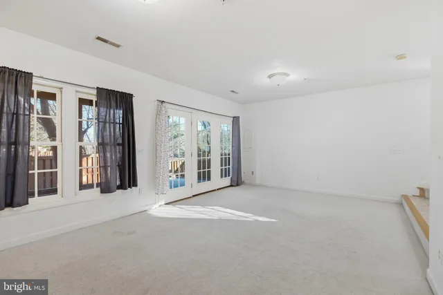 a view of a big room with windows and closet