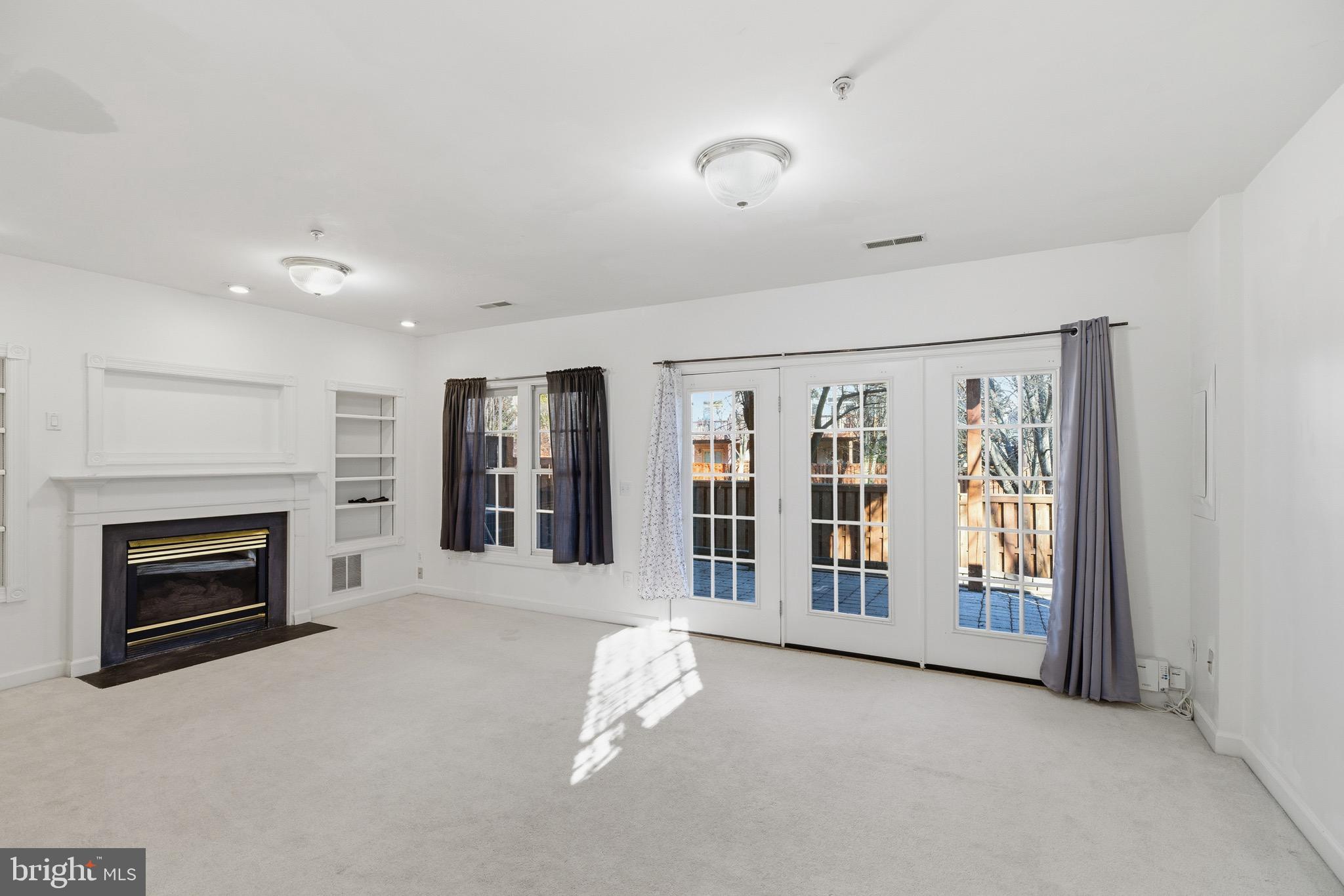 1817 Fallbrook Lane Vienna, VA 22182 - Photo 35 of 50 an empty room with windows and fireplace