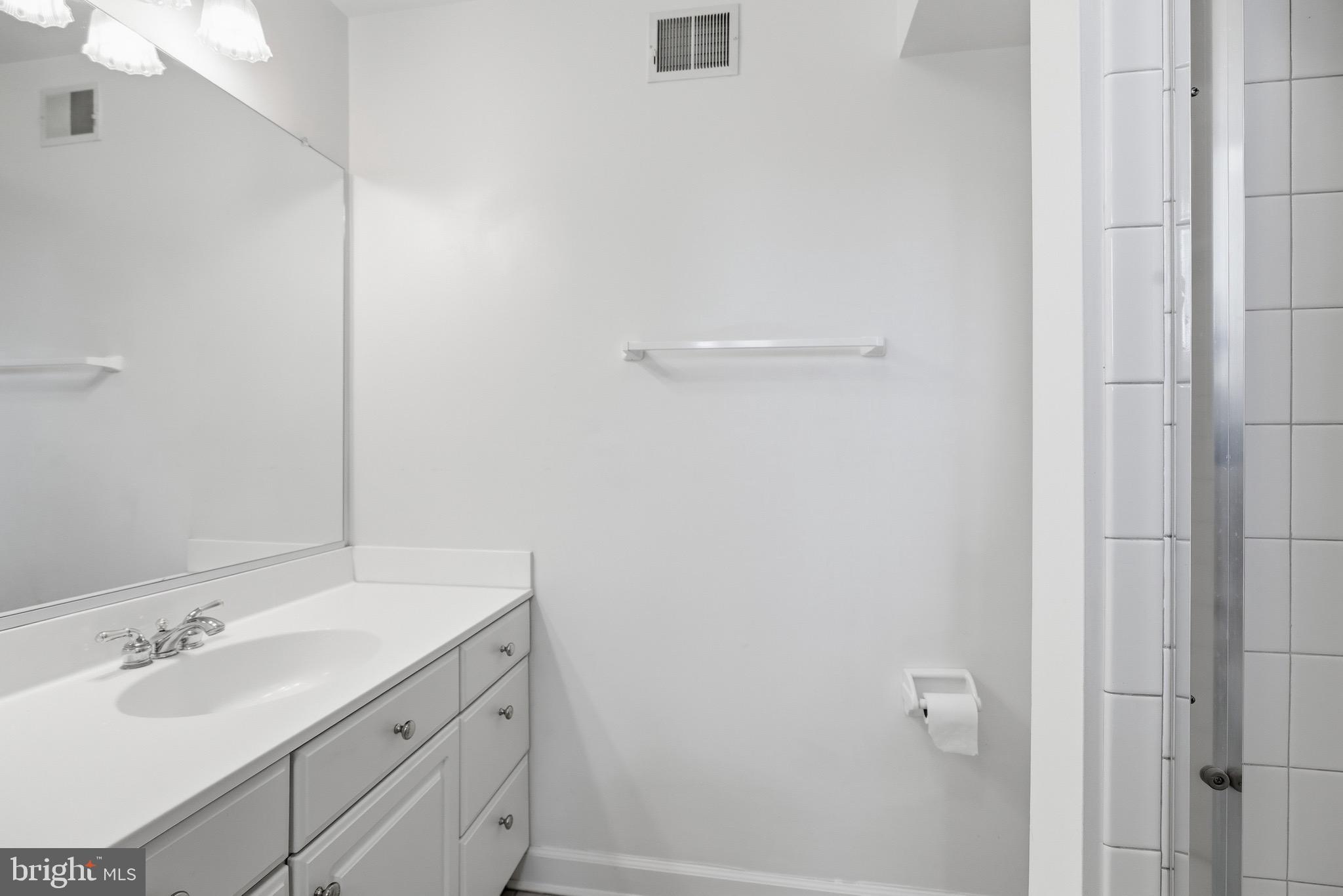 1817 Fallbrook Lane Vienna, VA 22182 - Photo 36 of 50 a bathroom with a sink and a mirror