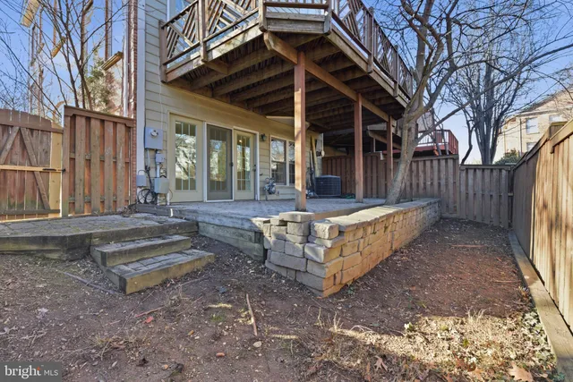 a view of a house with a yard and wooden fence