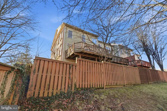 a view of a backyard with wooden fence