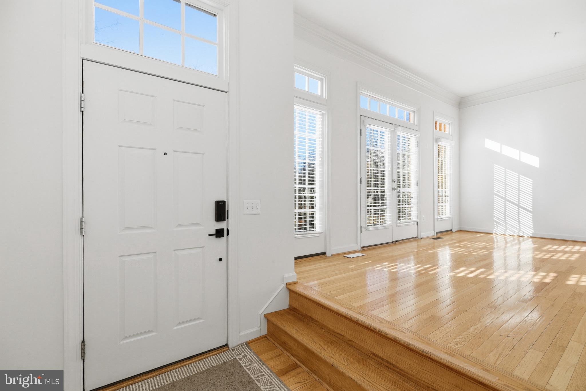 1817 Fallbrook Lane Vienna, VA 22182 - Photo 5 of 50 a view of an empty room with wooden floor and a window