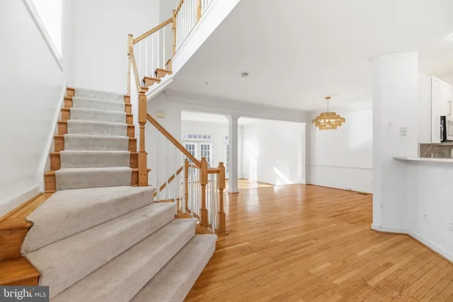 a view of entryway and hall with wooden floor