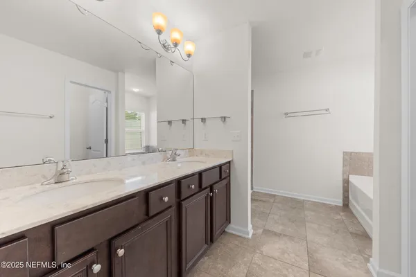 a bathroom with a sink a vanity and a mirror