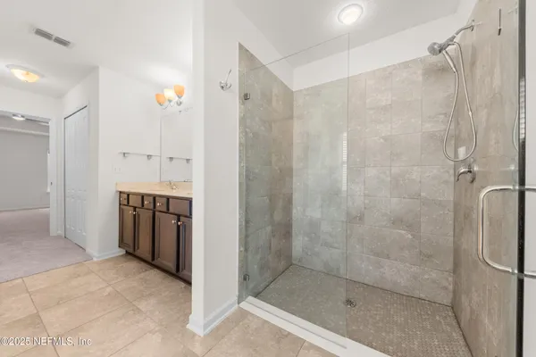 a bathroom with a shower and a sink