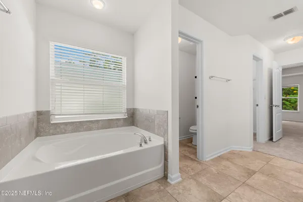 a bathroom with bathtub and a shower