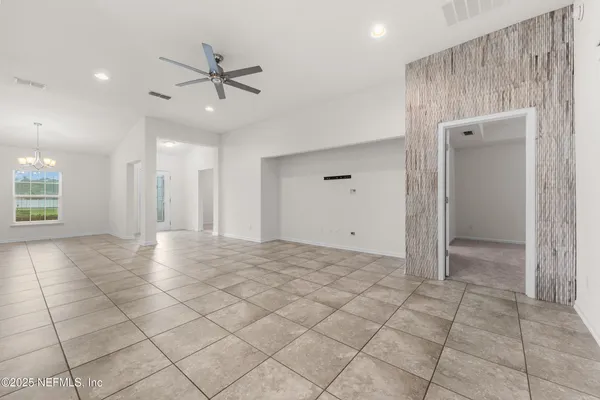 a view of a livingroom with a ceiling fan and window