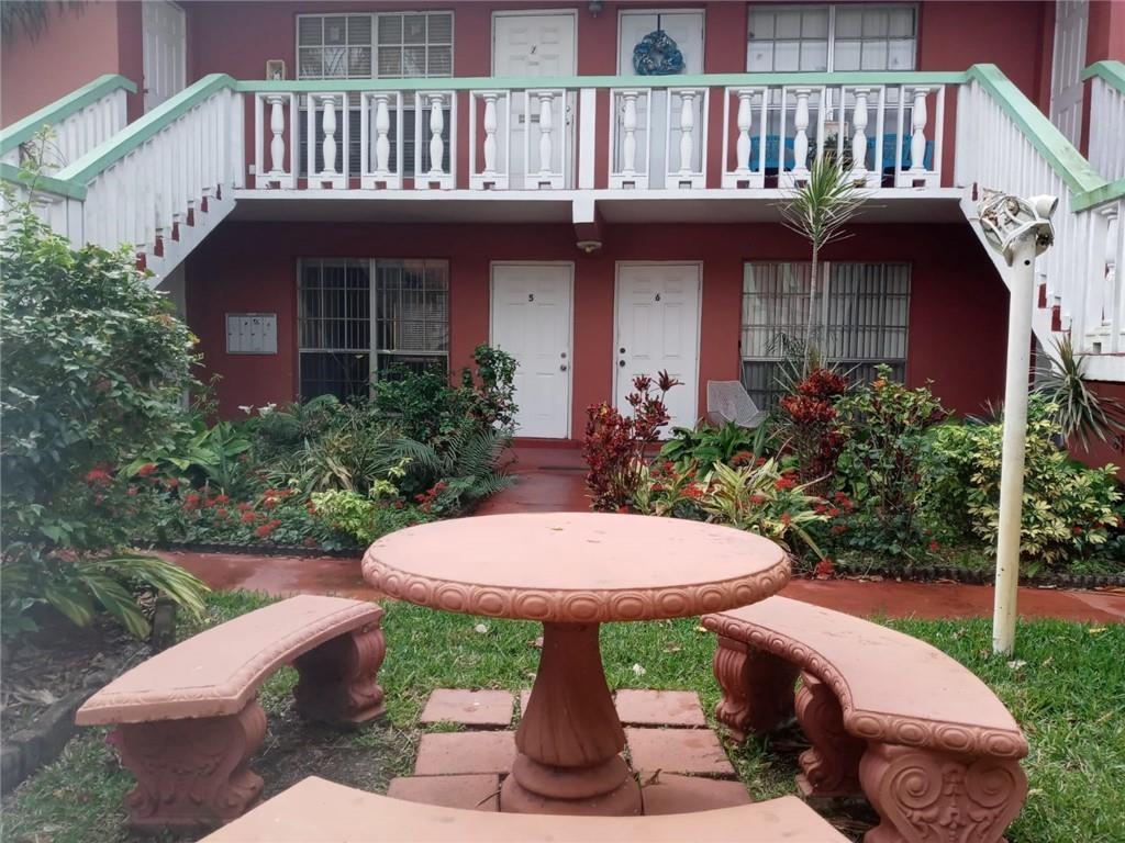 Undisclosed Address Sunrise, FL 33313 - Photo 1 of 15 a view of a patio with table and chairs and potted plants