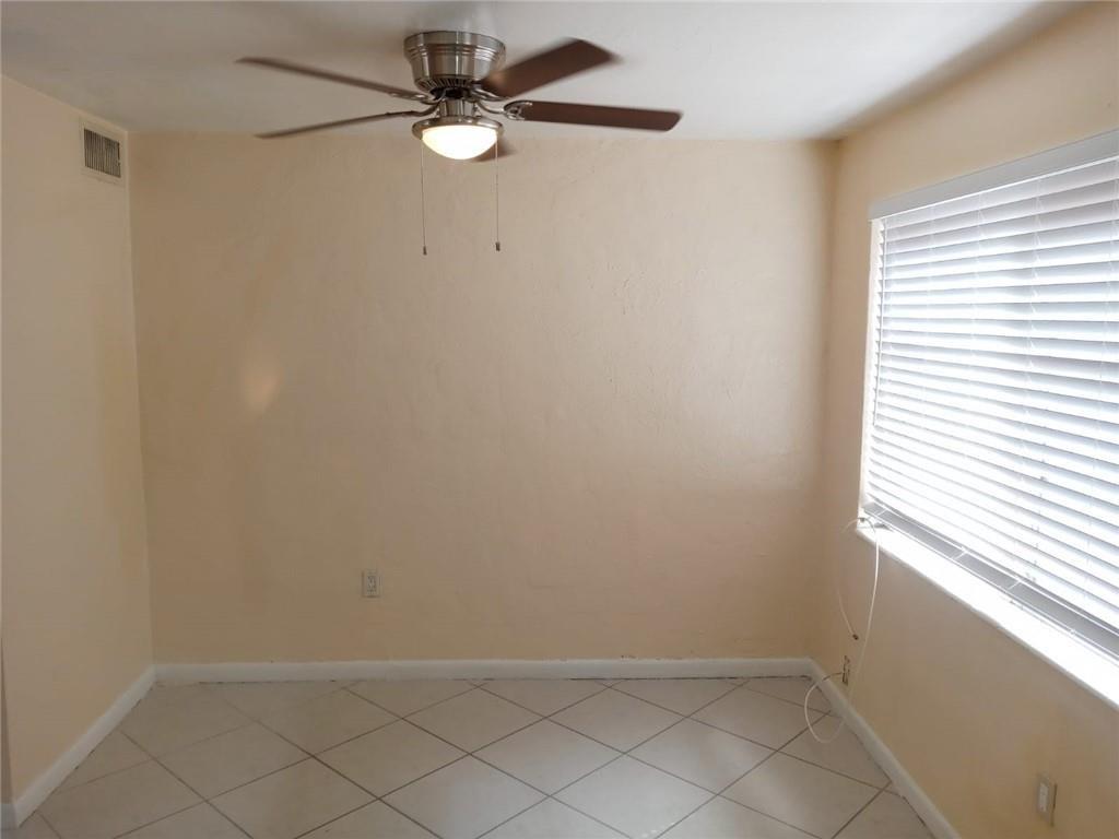 Undisclosed Address Sunrise, FL 33313 - Photo 12 of 15 an empty room with a window and a fan